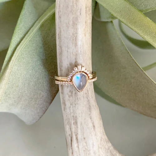 Custom designed wedding set in 14 karat rose gold and rainbow moonstone with diamond accents.